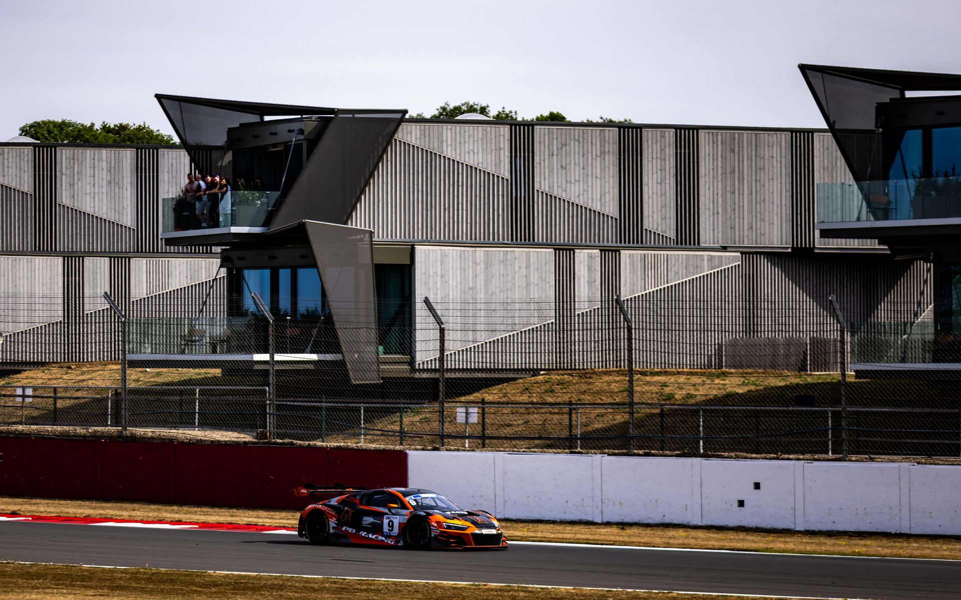 The car passing the hospitality suite overlooking the circuit